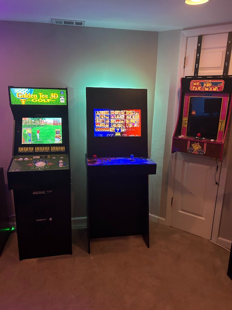 The finished DIY cabinet in its new home, standing proudly alongside the Arcade1Up Golden Tee and Ms. Pac-Man